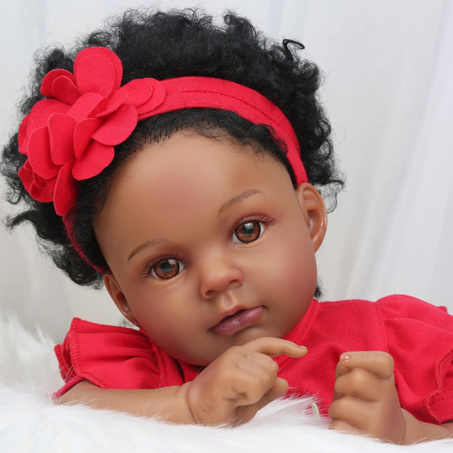 Realistic Baby Doll Nala from Kaydora is one of the perfect gift for kids, first-time parent, the elderly. It is because she has lifelike features such as hand-rooted hair and eyelashes, african american skin, brown eyes, and realistic paint fingers. She will help kids learn to love and do role-play activities.